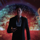 The Illusive Man smokes a cigarette while standing in front of a dying sun in Mass Effect Legendary Edition.